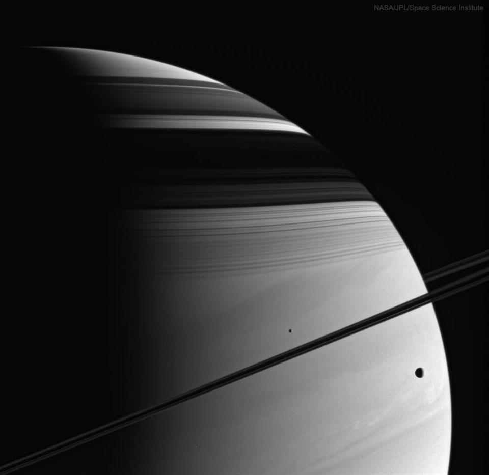 Cassini spacecraft view of Saturn showing rings, moons Mimas and Tethys, and cloud bands