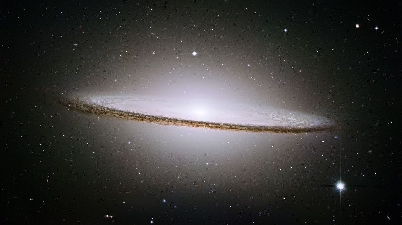 The Sombrero Galaxy (M104), an edge-on spiral with a bright bulge and prominent dust lane, imaged by the Hubble Space Telescope
