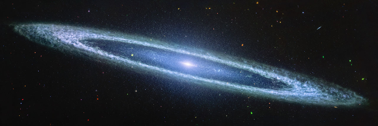 James Webb Space Telescope MIRI mid-infrared image of the Sombrero Galaxy (Messier 104), showing the galaxy's oblong blue disk and clumpy outer ring against the black of space
